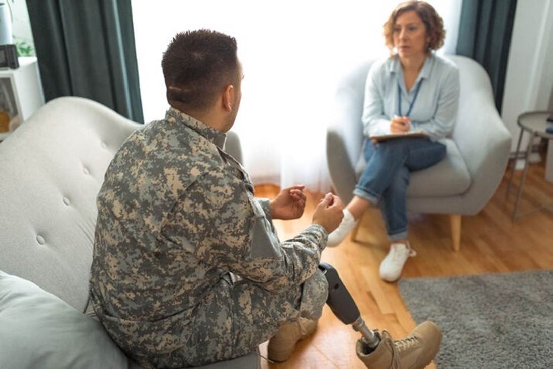 A soldier sitting on the floor talking to a person

AI-generated content may be incorrect.